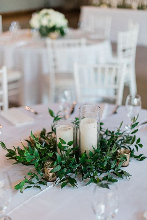 Greenery Tablescape Round Table, Round Table With Greenery, Morning Wedding Reception Decoration, Round Greenery Centerpiece, Greek Centerpieces Table Decorations, Greens And Candles Centerpieces, Candle Table Arrangements, Greenery Ring Centerpiece, White And Greenery Wedding Centerpieces Round Table