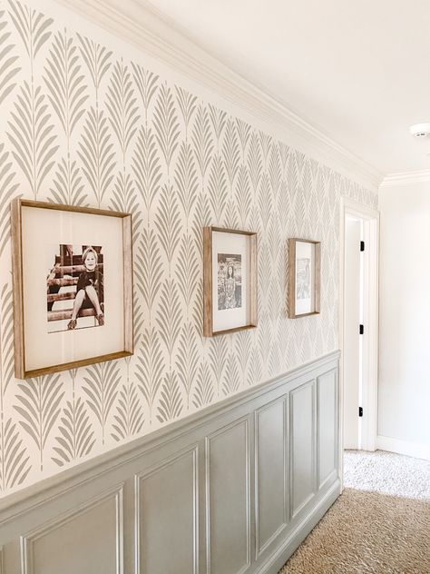 This hallway needed a makeover badly! I chose a stencil from stencil revolution and my husband put up wainscoting. Base color is SW alabaster #hallwayideas #hallwaydecor #wallpaper #frenchcottage #farmhousedecor #gallerywallideas #wainscoting #wainscotingstyles #farmhousedecor #paintcolorideas #frenchfarmhouse Bedroom Wallpaper Half Wall, Board And Batten Wall Wallpaper Above, Wallpaper Down Hallway, Paneled Entryway Foyers, Painted Wanes Coating Wall Colors, Hallway Paint Colors With Wainscoting, Modern Farmhouse Dining Room Wallpaper, Wall Treatments For Hallways, Hallway With Accent Wall