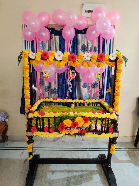 With flowers,ribbons and balloons Cradle Decoration At Home, Simple Cradle Decoration At Home, Simple Cradle Ceremony Decorations, Cradle Decoration Ideas At Home, Name Ceremony Decoration At Home, Cradle Decoration Ideas, Cradle Ceremony Decoration, Simple Balloon Decoration, Cradle Decoration