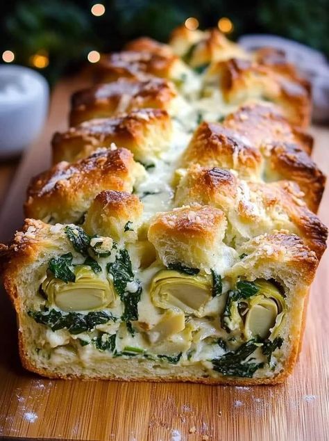 Spinach Artichoke Dip Pull-Apart Christmas Bread 

Ingredients:

1 loaf refrigerated pizza dough
1 cup shredded mozzarella cheese
1/2 cup grated Parmesan cheese
1 cup fresh spinach, chopped
1 cup canned artichoke hearts, drained and chopped
1/2 cup cream cheese, softened
1/4 cup sour cream
1/4 cup mayonnaise
2 cloves garlic, minced
1 tsp dried oregano
1/2 tsp salt
1/4 tsp black pepper
2 tbsp chopped fresh parsley (optional)
Instructions:

Preheat Oven:

Preheat your oven to 375°F (190°C) and grease a bundt pan.
Prepare Spinach Artichoke Mixture:

In a medium bowl, mix the cream cheese, sour cream, mayonnaise, garlic, oregano, salt, and pepper until smooth. Stir in the mozzarella, Parmesan, spinach, and chopped artichoke hearts.
Prepare the Dough:

Roll out the refrigerated pizza dough on a Pull Apart Cheese Bread, Artichoke Bread, Refrigerated Pizza Dough, Fruit Appetizers, Christmas Bread, Recipes Appetizers And Snacks, Spinach Artichoke Dip, Artichoke Dip, Spinach Artichoke