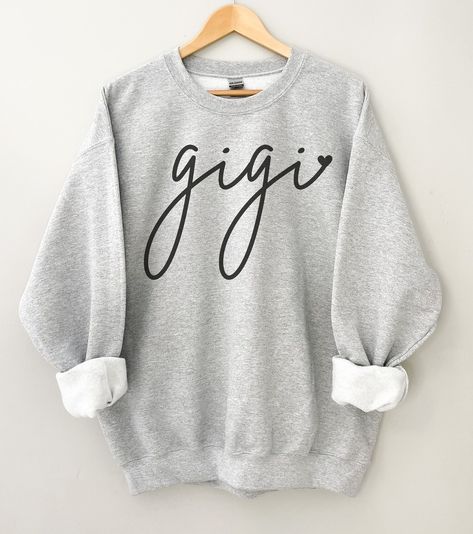 This Gigi sweatshirt is super comfy and makes a great gift for Gigi on any occasion. Get one for yourself or as a gift to your Gigi. This is a gift that is sure to bring a smile to Gigi's face. PRODUCT DETAILS - Gildan 18000 is heavy blend fleece crew sweatshirt - 50% cotton, and 50% polyester - Ribbed knit makes the collar highly elastic and helps retain its shape - Unisex fit - please refer to the size chart in the listing photos for most accurate measurement DESIGN AND PRINT INFORMATION - Dir Grammy Sweatshirt, Granny Shirts, Mrs Sweatshirt, Bride Sweatshirt, Grandma Sweater, Birthday Gifts For Grandma, Just Engaged, Heart Sweatshirt, Future Mrs