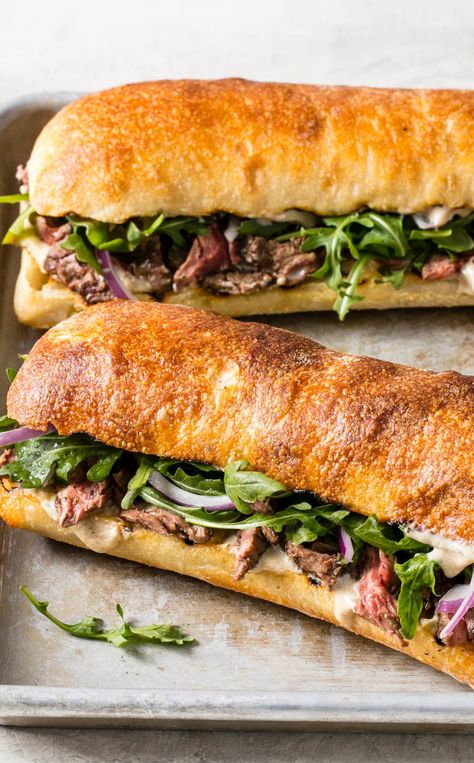 Grilled Steak Sandwiches: Tender meat, a bold blue cheese sauce, and peppery arugula define this classic lunch. Blue Collar Lunch Ideas, Gordon Ramsay Steak, Steak Sandwich Recipes, Steak Sandwiches, Blue Cheese Sauce, Rustic Recipes, Tender Meat, America's Test Kitchen Recipes, Steak Sandwich