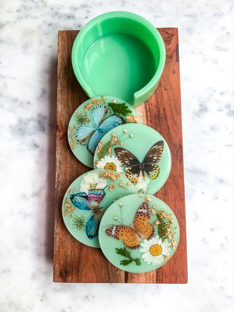 These beautifully hand crafted dual-later coasters are individually made with high quality jadeite colored resin, butterfly decals, real pressed flowers, and gold leaf.

• 4 coasters + caddy included
• Cork bottoms are anti-scratch and nonslip 

Each coaster is 3” in diameter.
Caddy is 4” in diameter and 1 1/2” tall Butterfly Resin Coasters, Butterfly Terrarium, Porcelain Designs, Butterfly Coasters, Butterfly Resin, Resin And Clay, Resin Trays, Resin Butterfly, Resin Bookmarks