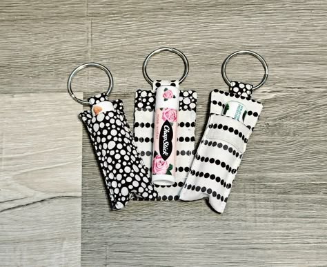 Three chapstick keychain holders, one white with black dots, one black with white polka dots, and one with the white fabric in front and the black dot fabric in back. Lip Balm Holder Keychain, Diy Chapstick Holder, Diy Chapstick, Secret Sister Gift Ideas, Chapstick Keychain, Chapstick Holder Keychain, Lip Balm Keychain, Sewn Gifts, Fun Sewing Projects