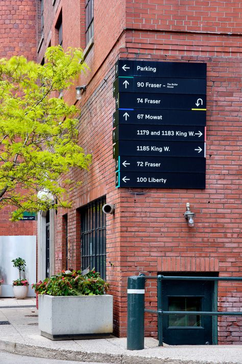 Toronto Carpet Factory — Bruce Mau Design Factory Signage, Bruce Mau Design, Bruce Mau, Wayfinding Signage Design, Factory Interior, Old Toronto, Office Signage, Retail Signage, Wood Table Design