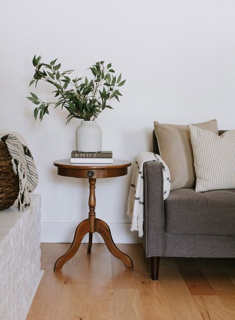 The little round end table trend - My vintage pedestal end table and 15 other little round end tables. Modern Traditional round pedestal tables, hourglass side tables, and 3 legged end tables. | Nadine Stay #endtable #sidetable #roundtable #vintagesidetable #vintagefurniture #moderntraditionaldecor #livingroomdecor #livingroominspo #pedestaltable #hourglasstable #flutedtable Side Tables Traditional, End Table For Couch, Round End Table Wood, Where To Place Side Tables In Living Room, Cute End Tables Living Room, Small Living Room Side Table, Side Table Decor Living Room Vintage, Traditional Side Tables In Living Room, Antique Wood Side Table