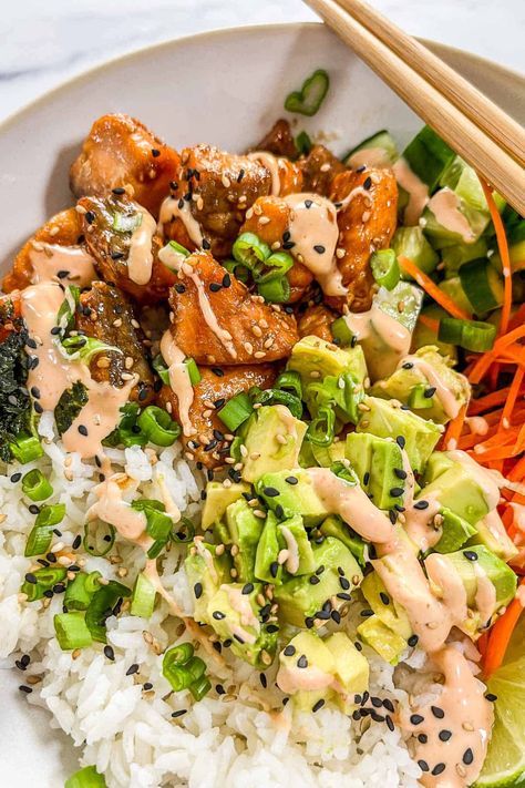 You'll love the flavor in these crispy salmon bowls with rice! They have the perfect balance of lightly crispy but still tender salmon bites paired with fresh veggies, sushi rice, a little bit of nori, and spicy mayo. This is a meal the whole family will love! Sticky Miso Salmon Bowl, Salmon Rice Bowl Air Fryer, Crispy Salmon Bowl, Salmon Sushi Bowl Recipe, Salmon Bowl Recipe, Salmon Sushi Bowl, Spicy Mayo Recipe, Salmon Poke Bowl, Sushi Bowl Recipe