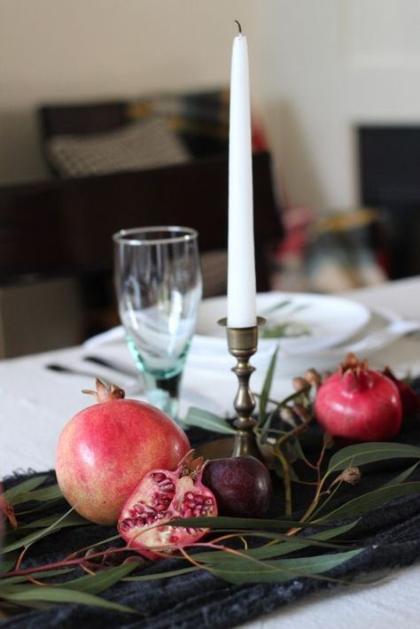 a simple and pretty fall centerpiece of a table runner, greenery, pomegranates and plums plus a tall candle Table Runner Greenery, Pomegranate Wedding, Pomegranate Decor, Fall Home Tour, Winter Fruit, Birthday Party Theme Decorations, Tall Candle, Red Pomegranate, Dinner Decoration