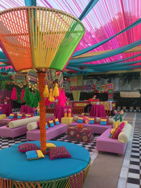 Haldi and Mehndi are the events where you can go quirky and unique with the decor. Carnival theme is all around colour and fun-filled ambience. Vibrant drapes, genda phool and some game stalls brighten up the whole decor done by Abhinav Bhagat Events at Radisson Blu Udaipur Palace Resort And Spa.#indianweddingdecor #weddingDecor #weddingdecorinspiration #decorinspiration #india #carnivalthemedecor #carnivaltheme #weddingdecorideas #decorideas #weddingideas #wedding #decorideasforwedding #mehndi Haldi Decor Ideas, Carnival Wedding Theme, Ambience Decor, Wedding Carnival, Haldi Decoration Ideas, Stall Decorations, Mehndi Function, Mehendi Decor Ideas, Haldi Decor