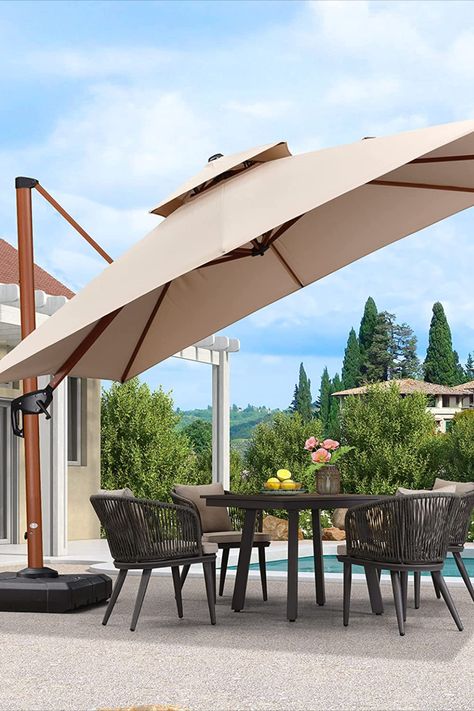 This heavy-duty cantilever umbrella is perfect for your garden, deck, or pool area. With a windproof design, it provides you with shade and protection from the sun. The umbrella's offset design maximizes your space. #patioumbrella #outdoorumbrella #cantileverumbrella #patiodecor #gardenumbrella #poolumbrella #beigeumbrella #outdoorliving #patiofurniture #outdoorfurniture #shade #sunprotection #windproof #offsetumbrella #purplleaf #heavyduty #summer #picnic #barbecue #backyard Barbecue Backyard, Beige Patio, Deck Pool, Pool Umbrellas, Umbrella Outdoor, Offset Umbrella, Garden Umbrella, Garden Deck, Cantilever Umbrella