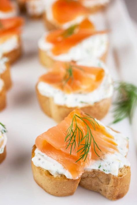 This Smoked Salmon Crostini recipe is an easy and flavorful appetizer! The crostini is toasted in the oven until crispy and then rubbed with garlic. It's topped with a creamy ricotta cheese mixture made with lemon juice, lemon zest, and fresh dill. The ricotta spread is added to the bread and topped with slices of smoked salmon. This Italian inspired appetizer is gluten free. It's perfect to serve at parties any time of the year! This dish is full of flavor and fun to eat. Smoked Salmon Crostini, Salmon Crostini, Ricotta Spread, Smoked Salmon Appetizer, Ricotta Crostini, Crostini Recipe, Salmon Appetizer, Ricotta Cheese Recipes, Crostini Appetizers