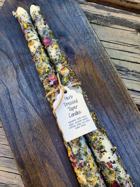 Comes in a set of two taper candles with a decorative tag and hand tied with twine. These beautiful taper candles are hand rolled in organic herbs and flowers.  These are perfect for any candelabra and burn evenly all the way through. 🔥  Just stick in any candle holder and hypnotize yourself while the wax rolls over the colorful flower petals 🥰 These candles are dressed in a mixture of Nettle leaves, Ginger, Spearmint, Organic tumeric, Sunflower petals, Rose petals and Mallow flower petals.  D Herb Rolled Candles, Dried Flower Taper Candles, Dressed Candles, Unique Taper Candles, Smudge Sticks Diy, Herb Spell Candles, Candle With Flowers, Diy Taper Candles, Candles Ritual