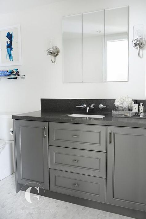 Fabulous bathroom features a dark gray extra wide single washstand topped with black granite fitted with a white porcelain sink and a backsplash mounted faucet placed directly under a 3 panel mirror. Grey Bathroom Countertops, White Granite Bathroom, Dark Grey Bathroom, Organization Apartment, Granite Bathroom Countertops, Dark Gray Bathroom, Bathroom Green, Granite Bathroom, Cheap Countertops