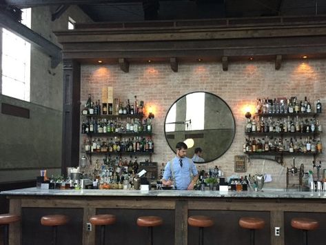 Round mirror behind bar Mirror Behind Bar, Mirror Shelves, Basement Wet Bar, Mirror Bar, Brewery Bar, Restaurant Design Inspiration, Palm House, Circle Mirror, Bar Mirror