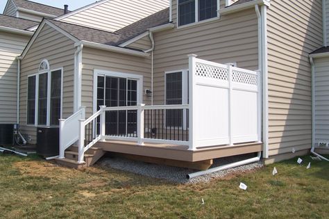 Whether you need a full, two-story deck with a pergola or a simple, smaller deck with a privacy fence like this one, let the professionals at Decks R Us help. We work with all types of homes and properties, so we know what will work for your needs and your budget. Ready to get started? Contact us today, and we'll be more than happy to give you a free estimate! #deckconstruction #deckideas #smalldeckdesigns Privacy Deck, Privacy Wall On Deck, Vinyl Gates, Deck House, Porch Awning, Vinyl Privacy Fence, Small Pergola, Privacy Wall, Deck Privacy