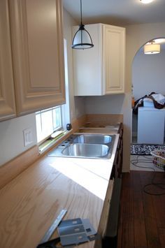 We also researched a sealer that would dry to a non-toxic finish (food safe) and make these countertops sturdy enough for a family of six–enter Waterlox Marine Sealer. Camelot Manor, Plywood Countertops, Plywood Kitchens, Beverly House, Wooden Countertops Kitchen, Plywood Countertop, Sink Window, Finish Food, Countertops Diy