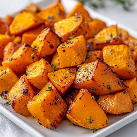 Golden roasted butternut squash cubes seasoned with herbs and spices, served on a white plate – Butternut squash recipes. How To Cook Cubed Butternut Squash, Roasting Butternut Squash Cubes, Dutch Oven Squash Recipes, Easy Way To Cook Butternut Squash, Pickled Butternut Squash, Roasted Cubed Butternut Squash, Butternut Squash Seasoning, Cubed Squash Recipes, Baby Butternut Squash Recipes