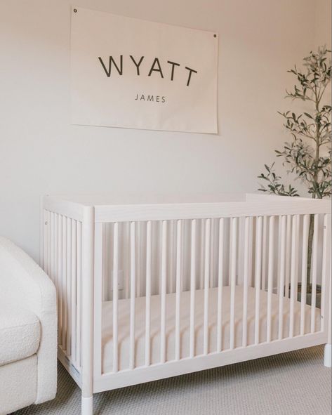 baby boy neutral nursery design. custom name sign, wooden crib, faux olive tree Follow my shop @thesunkissedlife on the @shop.LTK app to shop this post and get my exclusive app-only content! #liketkit #LTKkids #LTKfamily #LTKbaby @shop.ltk https://liketk.it/3zy6s Overtly Olive Nursery, Nursery With Olive Tree, Neutral Baby Nursery Cribs & Toddler Beds, Faux Olive Tree Nursery, Neutral Nursery Grey Crib, Name Above Crib Boy, Name Above Crib, Neutral Boy Nursery, Wooden Crib