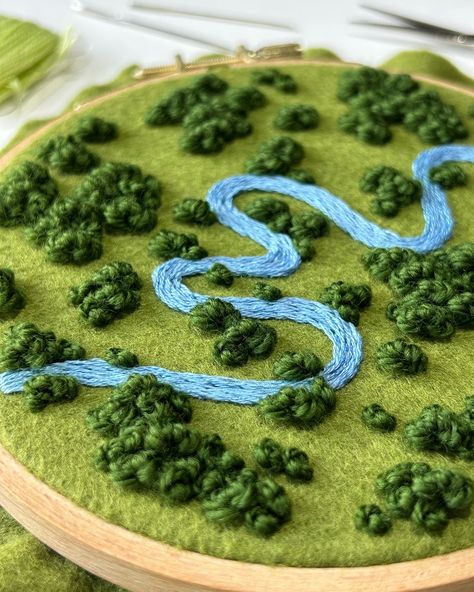 Progress on this floral river landscape ✨ Do you like this crazy winding river? Let me know! I found some aerial photos with twisting and turning rivers, and I really wanted to include all that movement into a piece. This is a 5 inch hoop with lots of movement and texture so far. I can’t wait to add the flowers! . . . @dmc_embroidery @dmc_crafts #embroidery #embroidered #needlework #handembroidery #fiberart #fibreart #textileart #dmc #threads #dmcthreads #embroideryartist #embroideryart #... Aerial Landscape Embroidery, Punch Embroidery Ideas, Embroidery Landscape Easy, Embroidered Scenery, Aerial Embroidery, River Embroidery, Garden Embroidery Designs, Weather Embroidery, Grass Embroidery