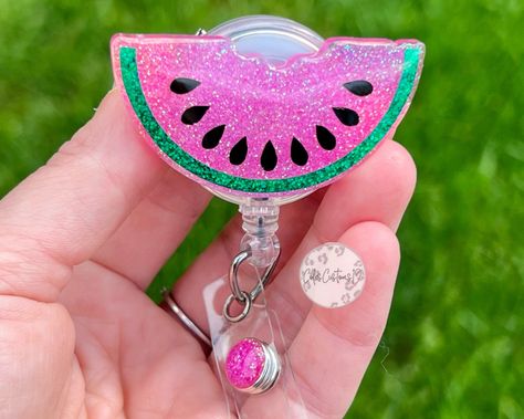 "Overview: -This Watermelon Badge Reel is a 2\" acrylic piece that is handmade using resin, glitter and vinyl, and is sealed with resin to add that smooth, lasting touch. Each reel is added to a retractable alligator clip that allows for a 360 degree access. The jewel will match each badge reel. This badge reel is the perfect accessory for your badge holder this summer.  Badge Reel Options: * Lanyard Badge Reel * Alligator Badge Reel * Belt Clip Badge Reel PLEASE NOTE: I am not responsible for c Summer Badge Reel, Teacher Badge Reel, Badge Reels Diy, Resin Badge, Epoxy Crafts, Teacher Badge, Badge Buddy, Resin Glitter, Nurse Badge Reel