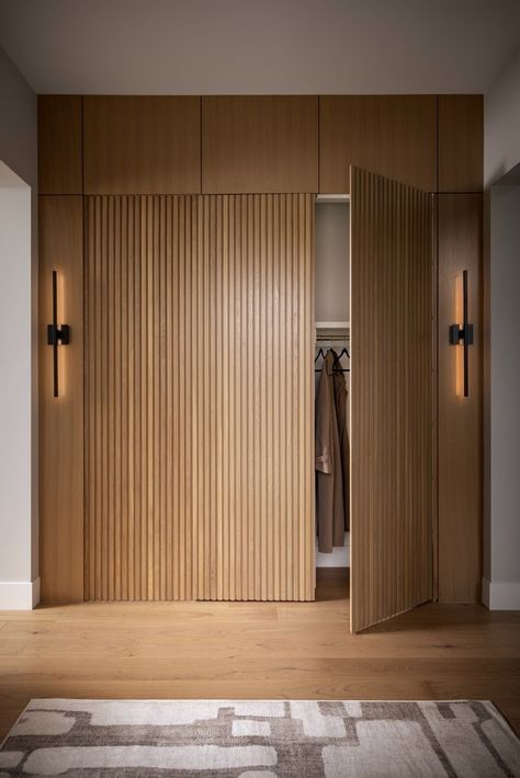 Lakeview by Trickle - Custom Homebuilding & Architectural Design Modern Entryway Closet, Entry Closet Ideas, Reeded Wood, Light Wood Flooring, Modern Black Wall, Black Wall Sconces, Hall Wardrobe, Hidden Closet, Mid Century Modern Exterior