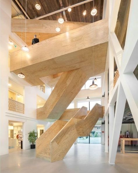 This building features a series of timber staircases which connect the different levels and the different functions. The staircases intersect and communicate and they have a very sculptural look Stair Design Architecture, Building Stairs, Stairs Architecture, Mix Use Building, Wood Architecture, Wooden Staircases, Wooden Stairs, Wood Stairs, Interior Stairs