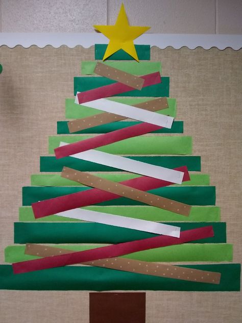 Simple strips of bulletin board paper. Christmas Tree For Bulletin Board, Christmas Tree Bulletin Boards, Simple Christmas Bulletin Board Ideas, 3d Christmas Tree Bulletin Board, Bulletin Board Christmas Tree, Paper Strip Christmas Tree, Christmas Tree Bulletin Board Ideas, Christmas Tree Bulletin Board, Simple Bulletin Board Ideas