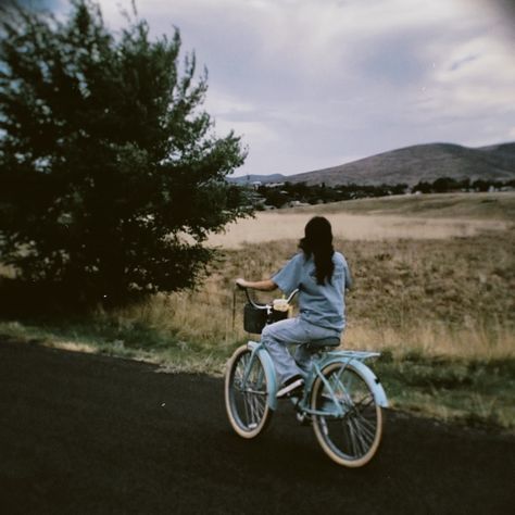 girl riding blue bike with basket on the street with mountain scenery Aesthetic Bikes With Basket, Bike Pictures Aesthetic, Blue Bike With Basket, Bike With A Basket, Bike Riding Astethic, Bike Asthetic Picture, Bicycle Ride Aesthetic, Bike With Basket Aesthetic, E Bike Aesthetic