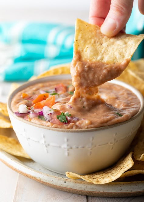 The Best Homemade Bean Dip Recipe - It's easy to make delicious, creamy, scoop-able bean dip right at home! Our AMAZING restaurant-style best bean dip recipe can be made on the stove or using an Instant Pot, with dried or canned beans. #homemadebeandip #easybeandip #bestbeandip #beandiprecipe #aspicyperspective Instant Pot Bean Dip, Home Made Bean Dip, Mexican Restaurant Bean Dip, Restaurant Style Bean Dip, Restaurant Bean Dip, Homemade Bean Dip, November Meals, Bean Dip Recipe, Dip Mixes