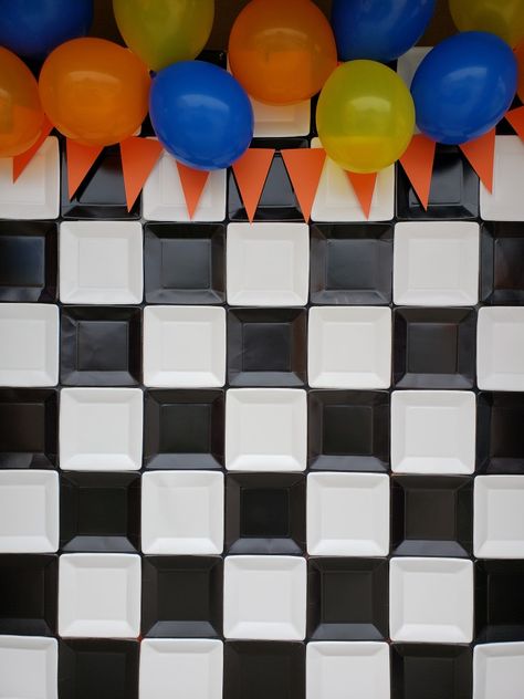 I went to Dollar Tree and bought 2 packs of 9in black paper plates and 2 packs of white. Laid them face down in the checkered patterned and taped them together. Hung it on my metal frame using small clamps. Added a paper flag banner and balloons to cover the frame and clamps... and BAM!... an awesome easy DIY photo backdrop for my son's 4th birthday party... for under $7! Black And White Checkered Party Decor, Paper Plate Backdrop Diy, Paper Plate Backdrop, Sonic Video Game, Post Prom Ideas, Checkered Backdrop, Video Game Party Ideas, Checkered Party, Bad Two The Bone