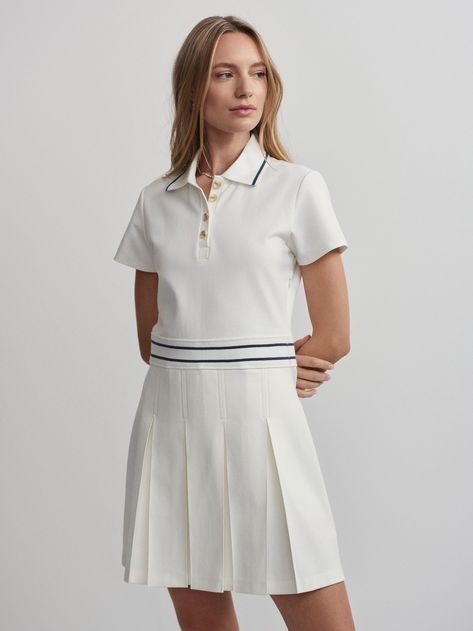 Made from a durable and structured fabric, this dress features a fitted, short sleeve top and button neck, with a pleated A-line skirt. Wear with a pair of your favorite Varley shorts underneath for additional coverage and support.