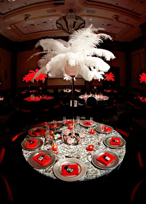 60th Birthday | Las Vegas | Casino Theme | Red | Black | White | Feathers | Grey Damask Linens | Silver Charger Plates #eventdecor #casino #centrepieces #tablescape #parasmehta Las Vegas Theme Gala, Vegas Gala Theme, Casino Hoco Theme, Viva Las Vegas Prom Theme, Casino Royale Gala, Las Vegas Theme Prom, Casino Homecoming Theme, Las Vegas Homecoming Theme, Casino Party Ideas Decoration