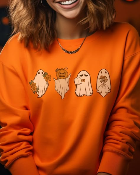 Halloween isn't complete without this retro pumpkin ghost sweatshirt! Get spooky and festive with this vintage-inspired style! 'Tis the season to get ghoulish and feel the chill in this comfy top. Spooky Season Clothes, Retro Pumpkin, Season Aesthetic, Ghosts Halloween, Fun Office, Spooky Party, Autumn Sweater, Ghost Sweatshirt, Spooky Szn