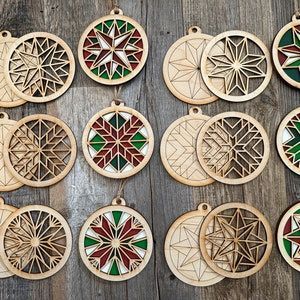 Make/paint your own beautiful barn Quilt ornaments Each kit contains: Six four inch in diameter (six different patterns) each has a base with etching to help paint the patterns and then a laser cut cutout of the pattern Two fine tipped paintbrushes Two flat paintbrushes Your choice of five paint colors- see last photo for options wood glue six strands of jute twine for hanging instructions/tips sheet All of this packaged and wrapped in a box!! Availability of paint colors may change 📞 If you w Wood Laser Gifts, Barn Quilt Ornaments, Wood Laser Engraving Machine, Laser Ornaments, Diy Barn Quilt, Ornaments Painting, Quilt Ornaments, Laser Cut Wood Jewelry, Ornament Painting