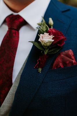 Burgundy Boutonniere Wedding, December Wedding Groom Attire, Boutineer Ideas Burgundy, Maroon Bouquet Wedding, Groom Suit Burgundy Wedding Colors, Burgundy And Blush Groomsmen Attire, Burgundy Corsage And Boutonniere, Burgandy Boutinere Ideas Groomsmen, Burgundy Wedding Boutonniere