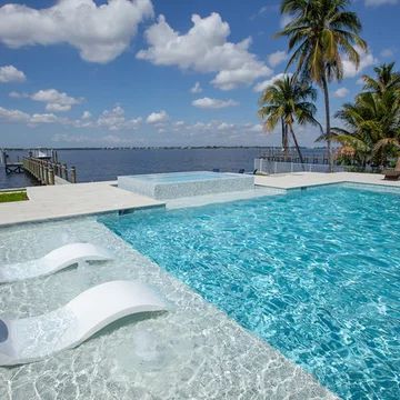 75 Modern Pool Ideas You'll Love - May, 2024 | Houzz Modern Pool Deck, Modern Swimming Pool Designs, Modern Outdoor Living Area, Florida Pools, Landscaping Driveway, Modern Swimming Pool, Lap Pool Designs, Sun Shelf, Pool Makeover