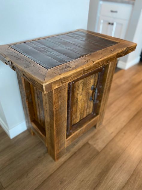 Beautiful one of a kind table made from reclaimed barn wood and hammered roof metal. Table would work great as a entry table, end table, or nightstand. Cabinet door is made from combing tobacco lath with a salvaged metal frame belonging to an antique John Deere tractor. Each lath has its own color and texture due to the spearing and staining process in harvesting tobacco. Table top consists of reclaimed hand hewn barn beams which frames a hammered smooth metal that once topped a 1890s barn. All the wood and metal has been brushed, sanded, and includes two coats of poly acrylic for a smooth finish. Nightstand Cabinet, Barnwood Ideas, Barn Wood Projects, Wood End Table, John Deere Tractor, Wood Tables, Table Nightstand, Wood End Tables, Entry Table