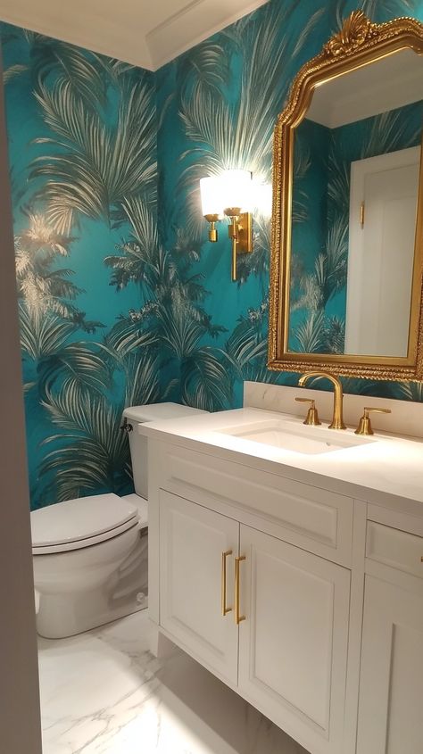 Bright teal wallpaper adorns a small powder room with a gold-framed mirror, white fixtures, and a marble floor, exuding Gold And Turquoise Bathroom, Wallpaper Bathroom Ceiling Ideas, Wallpaper For Bathroom Small Spaces, Light Teal Bathroom, Blue Powder Room Ideas, Blue Wallpaper Bathroom, Fun Powder Room Ideas, Powder Room With Pedestal Sink, Fun Powder Room