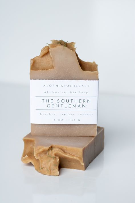 The Southern Gentleman Bar Soap & Loofah Bar Soap Bourbon, Cypress, Tobacco Moisturizing Bar Soap Bourbon, Cypress, Tobacco Exfoliating & Moisturizing Loofah Bar Soap Akorn Apothecary Soap & Skin Care products are made with natural botanical ingredients. A three piece linen suit, the fear of God, & a smile sweeter than honey on beignets. No woman is immune, but sunset porch dates are kept wholesome with well mannered conversation, iced tea, and a lingering kiss goodbye, on the hand of course. Th Homemade Soap Photography, Soap Product Shoot, Handmade Soap Photography, Natural Soap Packaging, Soap Loofah, Soap Packaging Diy, Natural Homemade Soap, Soap Photography, Kiss Goodbye