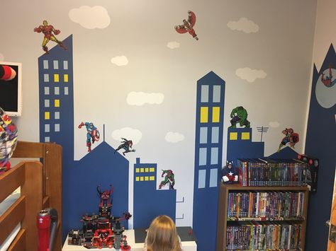 A lot of tape and paint later! Son loves it! Superhero Mural, Superhero Wall Mural, Boys Bedroom Ideas Superhero, Boys Superhero Bedroom, Cityscape Mural, Superhero City, Avengers Room