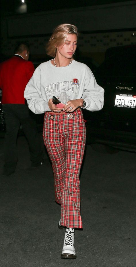 Hailey Bieber Wearing Red Plaid Pants And White Dr. Martens | Glamor and Gloss White Dr Martens Outfit, Red Pants Outfit, Plaid Pants Outfit, Red And White Outfits, White Dr Martens, Red Plaid Pants, White Boots Outfit, Dr Martens Outfit, Hailey Rhode