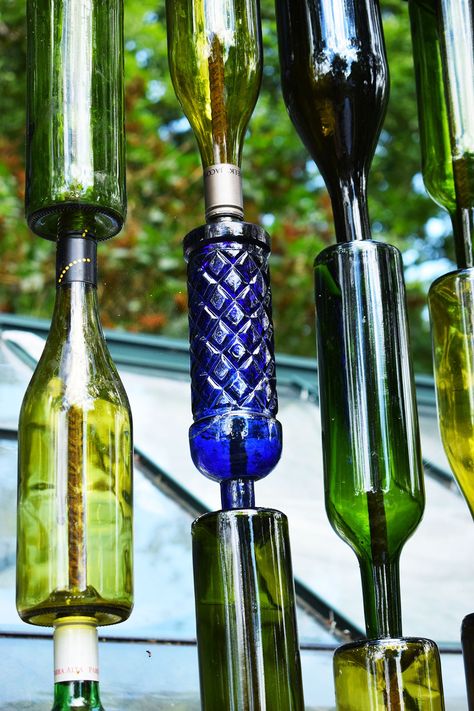 How to make a wine bottle screen garden feature - Caradise Wine Bottle Fence Ideas, Bottle Fence, Wine Bottle Rain Chain, Coke Bottles Crafts, Patron Bottle Crafts Diy, Wine Bottle Wall Outdoor, Diy Wine Bottle Crafts, Wine Bottle Fence, Wine Bottle Garden