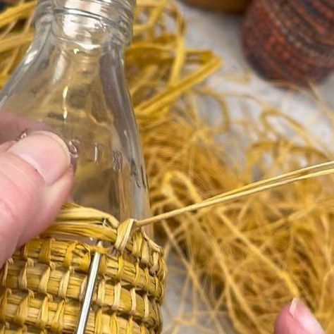 Ruth || Creative Teacher on Instagram: "Covering an upcycled bottle with raffia looks super cool. In our workshop Raffia baskets no 2 we show you how plus many more techniques and tips. Check out our online workshops. . . #Raffiabaskets #basketmaking #basketweaving #shapingabasket #australianbasketry #basketcoiling #slowcraft #coiledbaskets #craftschooloz #craftschoolozworkshops #crafternoon #craftastherapy #sharemycraft #nationalbasketryorganization #fibreart #fiberart #basketmakersofvictor Rafia Crafts, Eco-friendly Paper Straw Crochet Basket Bag, Paper Garland Ideas, How To Weave Raffia, Paper Garland Diy, Woven Sculpture, Eco-friendly Braided Straw Basket Bag, Eco-friendly Braided Basket Bag, Raffia Crafts