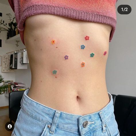 Small pastel flower tattoos scattered around a woman's stomach Funky Tattoos, Handpoke Tattoo, 4 Tattoo, Cute Little Tattoos, Cute Tiny Tattoos, Stomach Tattoos, Dainty Tattoos, Subtle Tattoos, Dream Tattoos