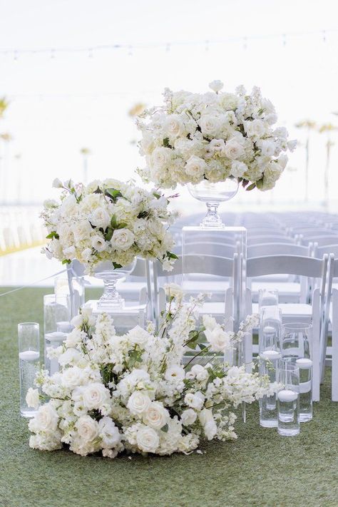 Wedding Flowers Floor Arrangements, Overhanging Flowers Wedding, Large White Centerpiece Wedding, Pedestal Flowers Wedding Ceremony, White Folding Chairs Wedding Ceremony, Ivory Wedding Florals, Floor Florals Wedding Ceremony, Wedding Decor White Flowers, White Wedding Centerpieces Elegant