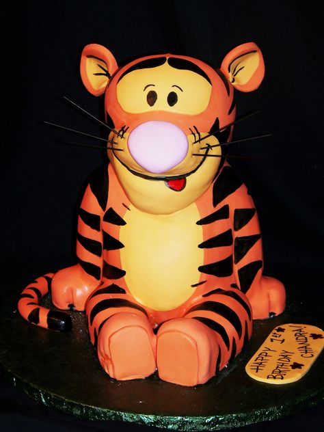 Tigger - Really should have used an internal wooden structure so I could make Tigger more long and lean looking....but I didn't....so he's fat.  :-)   (Just used a cardboard and some support straws and dowels through the center)  Oh well I guess he's recognizable!!!  haha. Tigger Cake Ideas, Tigger Birthday Cake, Tigger Cake, Tigger Birthday, Winnie The Pooh Cakes, Tiger Cake, Tigger Disney, Pooh Cake, Bolo Red Velvet