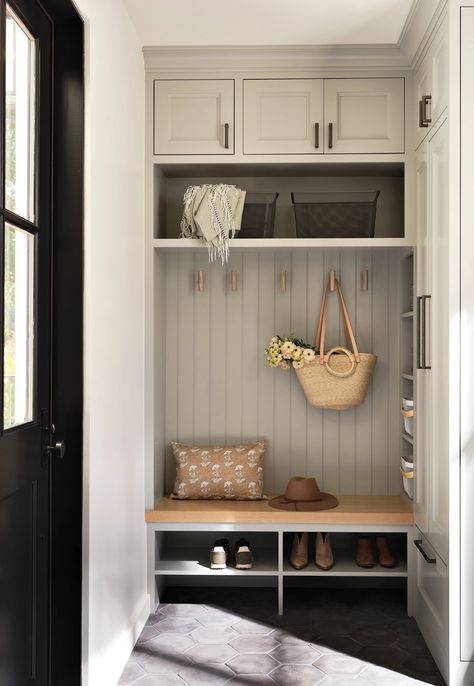 The mudroom was painted with Benjamin Moore’s Half Moon Crest, a sage-gray hue. The floor tiles are Arto, the cabinet hardware is by Top Knobs and the stained-ash hooks were designed by Kates Mudroom Ideas Entryway With Sink, Mcgee Mudroom, Small Mudroom Built In, Mudroom Ideas Beadboard, Small Mudroom Storage, Built In Shoe Shelves, Beadboard Entryway Hooks, Entry Mudroom Ideas, Shiplap Entry Wall With Hooks And Bench