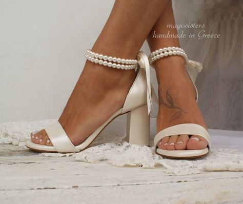 Classically beautiful, our 'LINDA' showcases double-strand pearl bracelets that tie around the ankles with satin ribbons for an eternally elegant look on your wedding day. These sandals crafted from high quality materials they feature a stylish toe strap, lightly cushioned leather insole and a sturdy wrapped block heel. Heel height pictured: 8cm (3,15''). Also available in 5cm (1.96''). We fully guarantee and stand by our handmade shoes, for their quality and durability. ~ The antiskid rubber so Bridal Shoes Pearl, Wedding Shoes Ivory, Ivory Sandals, Pearl Wedding Shoes, Ivory Heels, Elegant Minimalism, Ivory Wedding Shoes, Leather Sandals Handmade, Bridal Heels