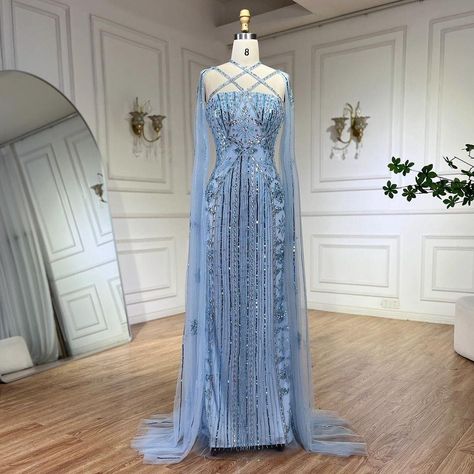 Capture the essence of elegance. Your journey begins at www.larosabride.com #ElegantJourney #EveningSplendour #larosabride Blue Mermaid Gown, Arabic Luxury, Gown With Cape, Beaded Cape, Blue Evening Gowns, Blue Cape, Mermaid Evening Gown, Blue Mermaid, Cape Sleeves