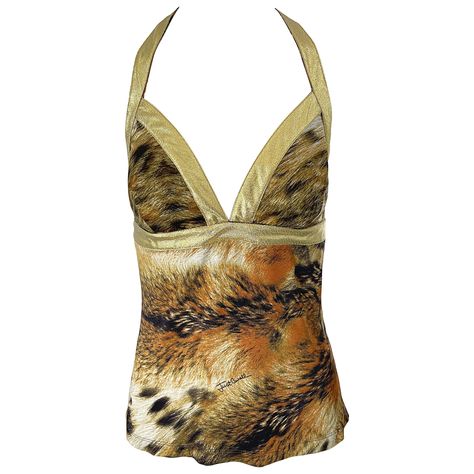 Sexy vintage early 2000s ROBERTO CAVALLI / Just Cavalli lion print and gold lame rayon jersey top ! Features an allover animal print with gold lame straps and racerback. Hidden zipper up the back with hook-and-eye closure. Can easily be dressed up or down. Great with shorts, jeans, a skirt, or trosuers. Would especially look stellar with white denim. In great unworn condition Made in Italy Marked Size Large Measurements: ( has some stretch ) 36 inch bust 32-34 inch waist Animal Print Aesthetic, Ramona Badwolf, Vintage Roberto Cavalli, Vintage Blouses, Gold Lame, Valentino Black, Lion Print, Racerback Top, Roberto Coin